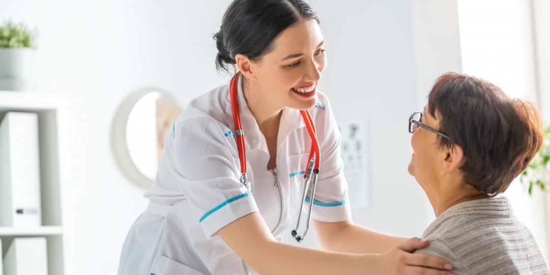 Female patient listening to doctor in medical office.